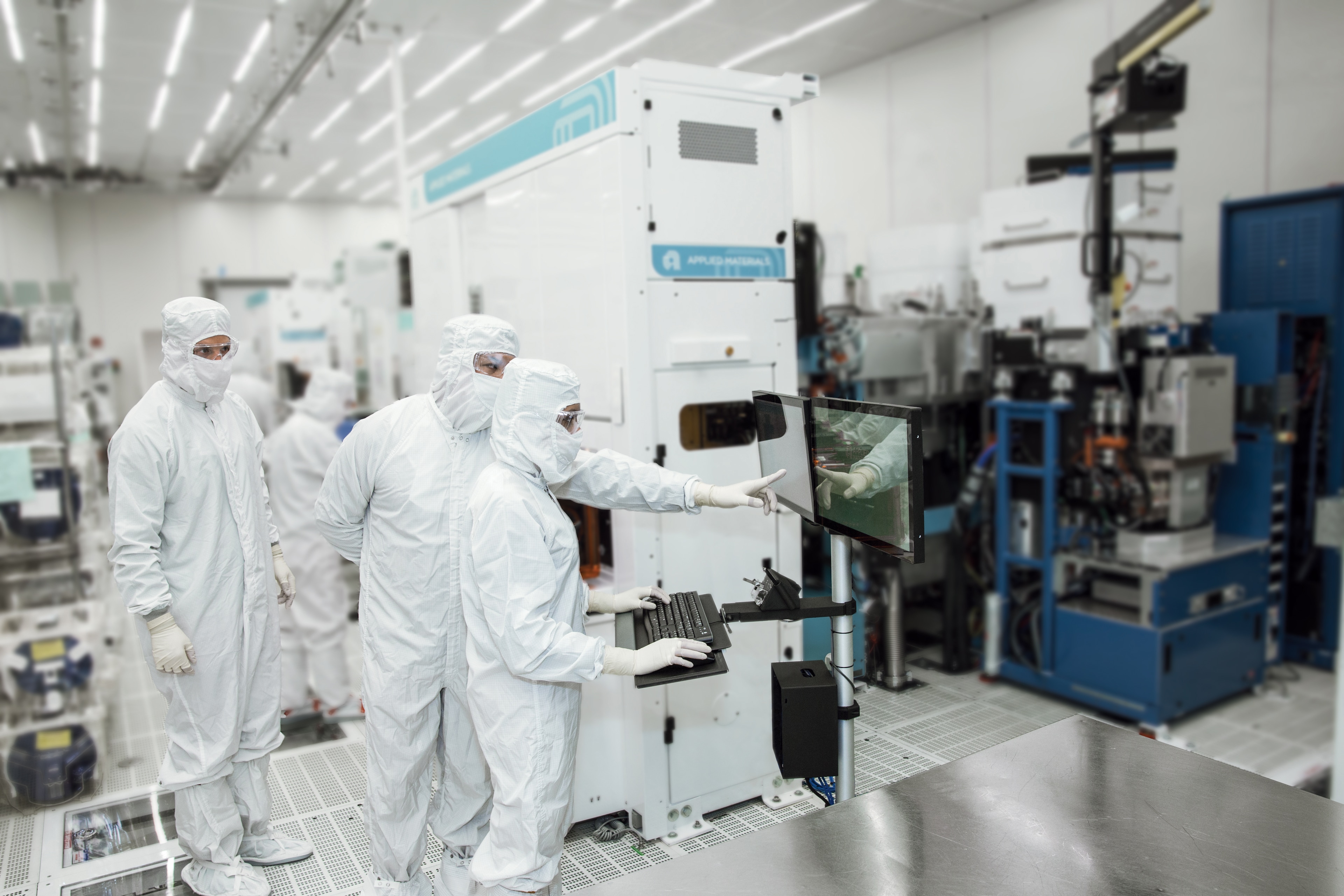 team reviewing system in cleanroom