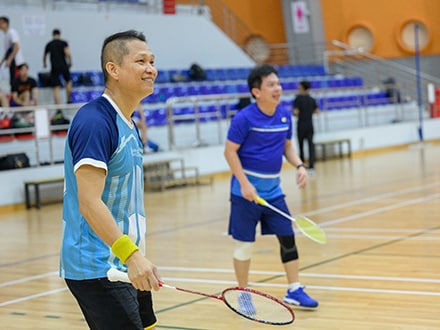 two people playing badminton